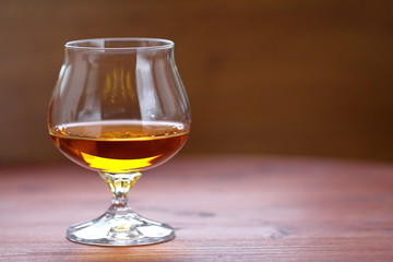 Glass of cognac on the table