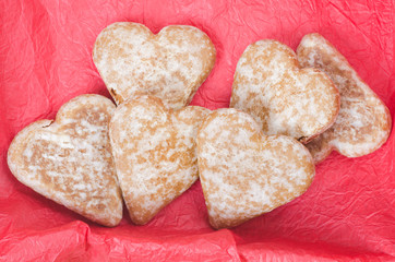 gingerbread heart cookies on red background