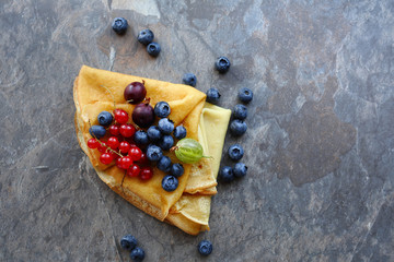 pancakes with berries on slate