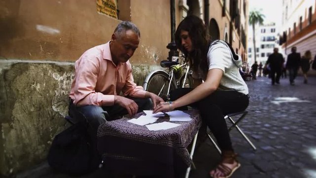 Male tarot card reader gives fortune on the street