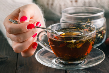Female make the herbal tea on rustic wooden table