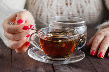 Female make the herbal tea on rustic wooden table