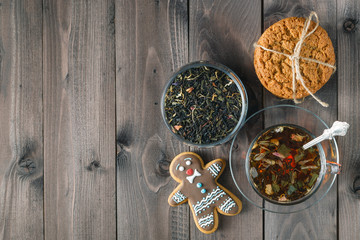 Hot herbal tea on dark aged wooden background