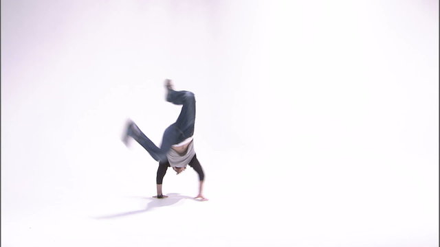 Break dancer spinning a one-handed handstand.