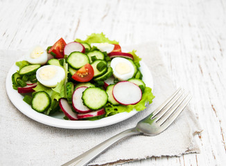 Spring salad with eggs, cucumbers and radish