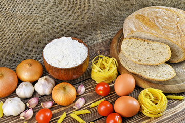 Still-life photo bread with pasta and vegetables with ingredients on a table for dinner
