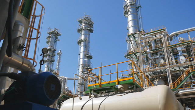 Refinery tower and steel pipe line in process area of Industrial refinery plant with blue sky 