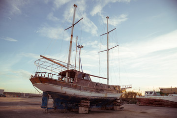 Vintage Wood Sail Boat in a Port out of the Water. Vintage Filter Applied.