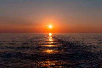 Sea sunset with ship trace
