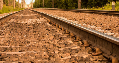 Obraz premium Railway receding into the distance. Along the railway poles - electric transmission line. 