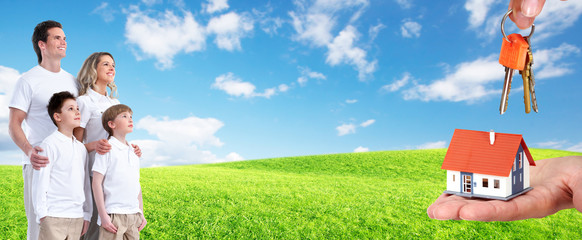 Happy family near new house.