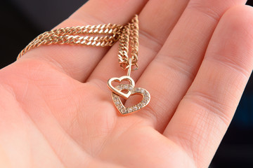 gold pendant in the shape of a heart on a Valentine's Day gift