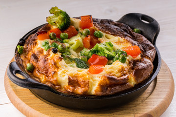 Fresh ham and cheese omelet in fry pan