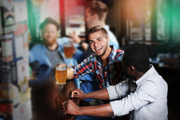 Young men drinking beer in pub