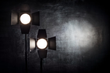 Lighting equipment on a black background old shabby wall
