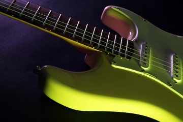 Obraz na płótnie Canvas Part of electric guitar, on dark lighted background