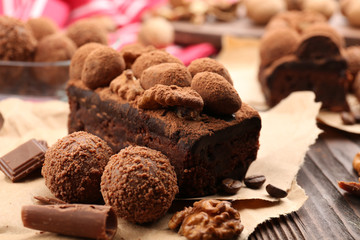 A piece of chocolate cake with walnut on the table, close-up