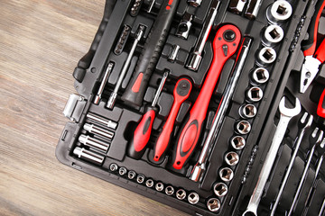 Tools in box on wooden background