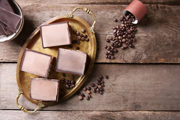 Delicious chocolate brownies on tray, on wooden background
