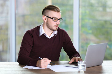 Businessman working with laptop in office