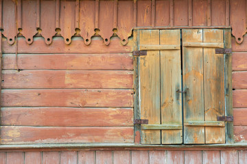 Exterior of the abandoned wooden building wall with closed window in Trakai, Lithuania.