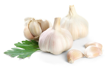 Garlic with leaves of parsley isolated on white
