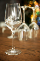 Empty wine glasses on wooden table against blurred background