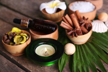 Beautiful spa setting on palm leaf on wooden table
