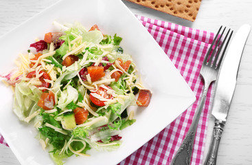 Tasty salmon salad on wooden table background