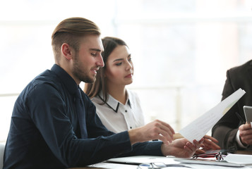 Young business people discussing a new project at the meeting in office