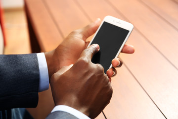 Afro american man with a smartphone indoor