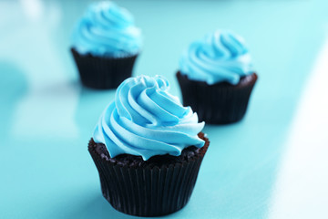 Chocolate cupcakes on blue background