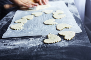 Woman cooking biscuits in kitchen