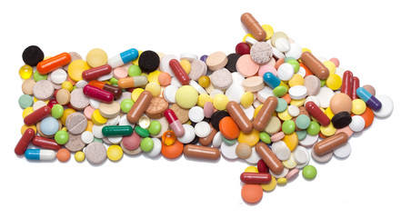 Arrow sign made of pills, capsules and tablets