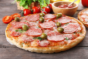 Delicious tasty pizzas with ingredients on table, closeup