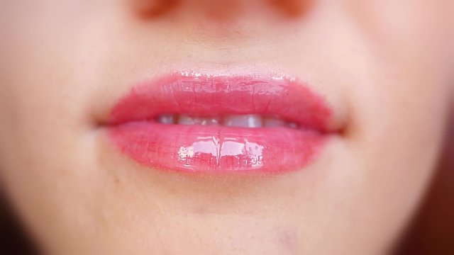Extreme close up of licking lips and smiling in slowmotion