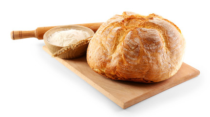 Bread with flour and ears on cutting board isolated on white