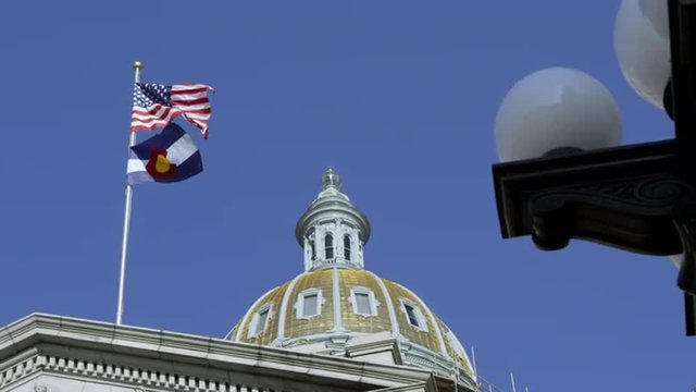 Slow motion zoomed view to the top of the Capitol Building in Colorado.