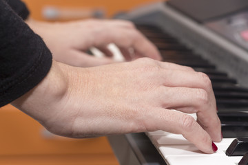 Close-up of hands playing the piano