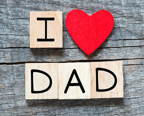 Wooden letters spelling I love dad with red heart 