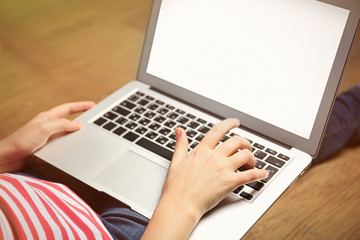 Woman sitting on the floor and working with a laptop