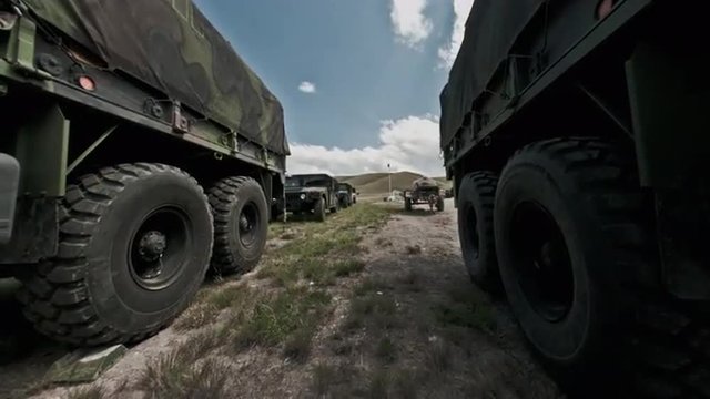 Time-lapse filmed between military convoy trucks.