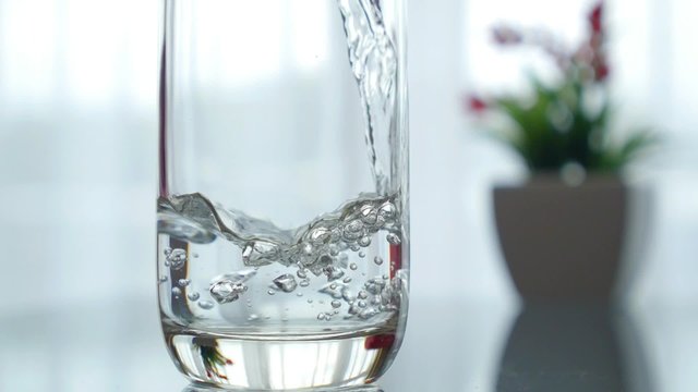 Pouring Water in a Glass. Closeup. 