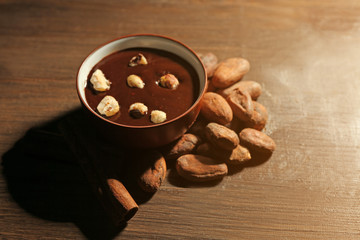 Aromatic cocoa harvest with tasty chocolate on wooden background, close up