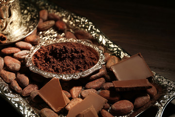 Silver tray with aromatic cocoa harvest, close up