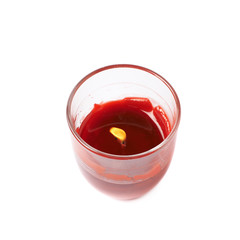 Half-burned lit red candle isolated