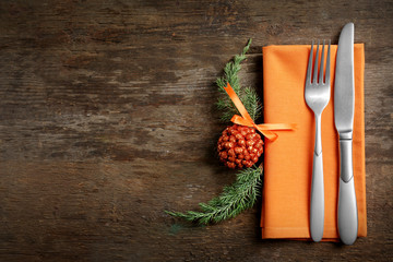 Christmas serving cutlery with napkin on a wooden background