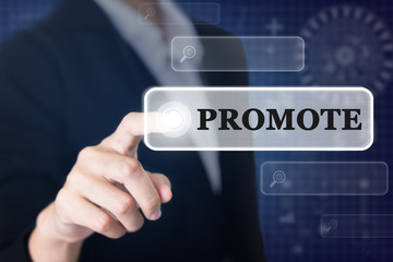 Businessman pressing a PROMOTE concept button. Can be used in advertising.