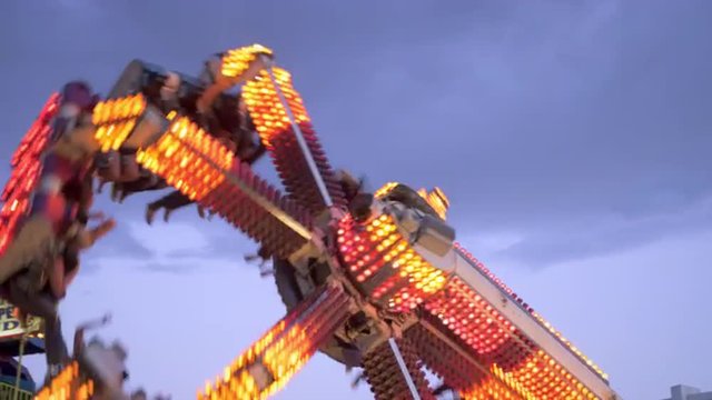 Shot of people flying through the air on a carnival ride
