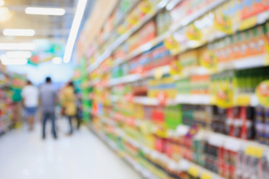 Many different drink bottles on supermarket shelves blurred back